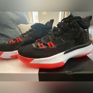 Big kid/boy size 4.5.  Jordan Zion 1 shoes in black, white, and neon orange/red.